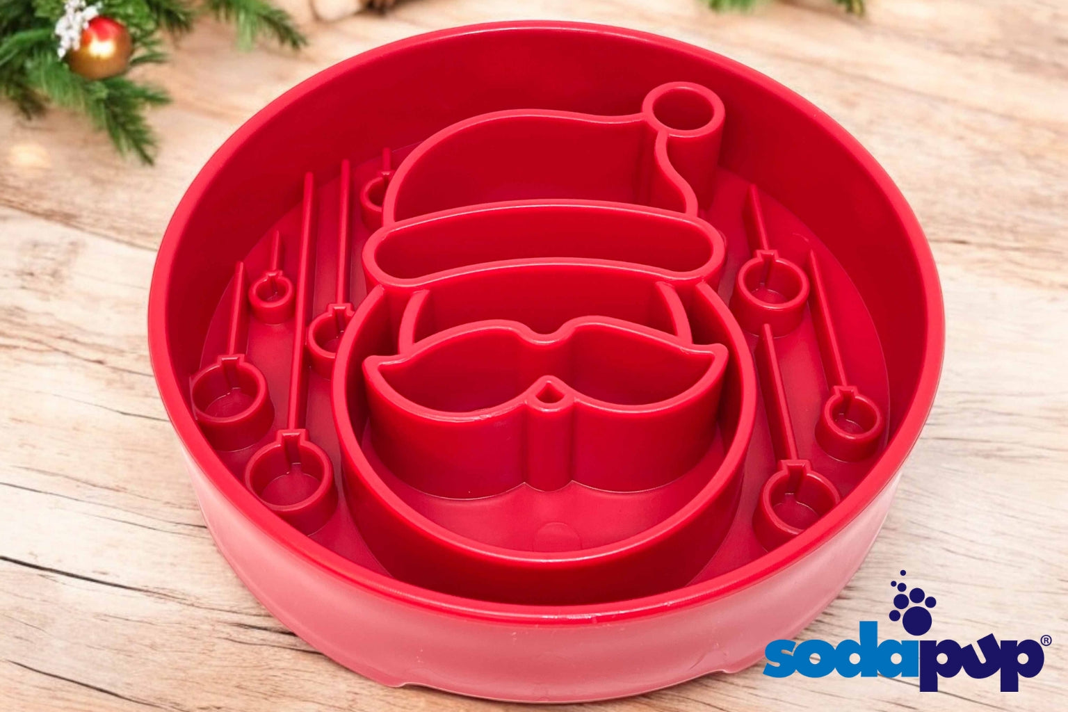 Red SodaPup brand slow feeder dog bowl with a Santa face shape inside