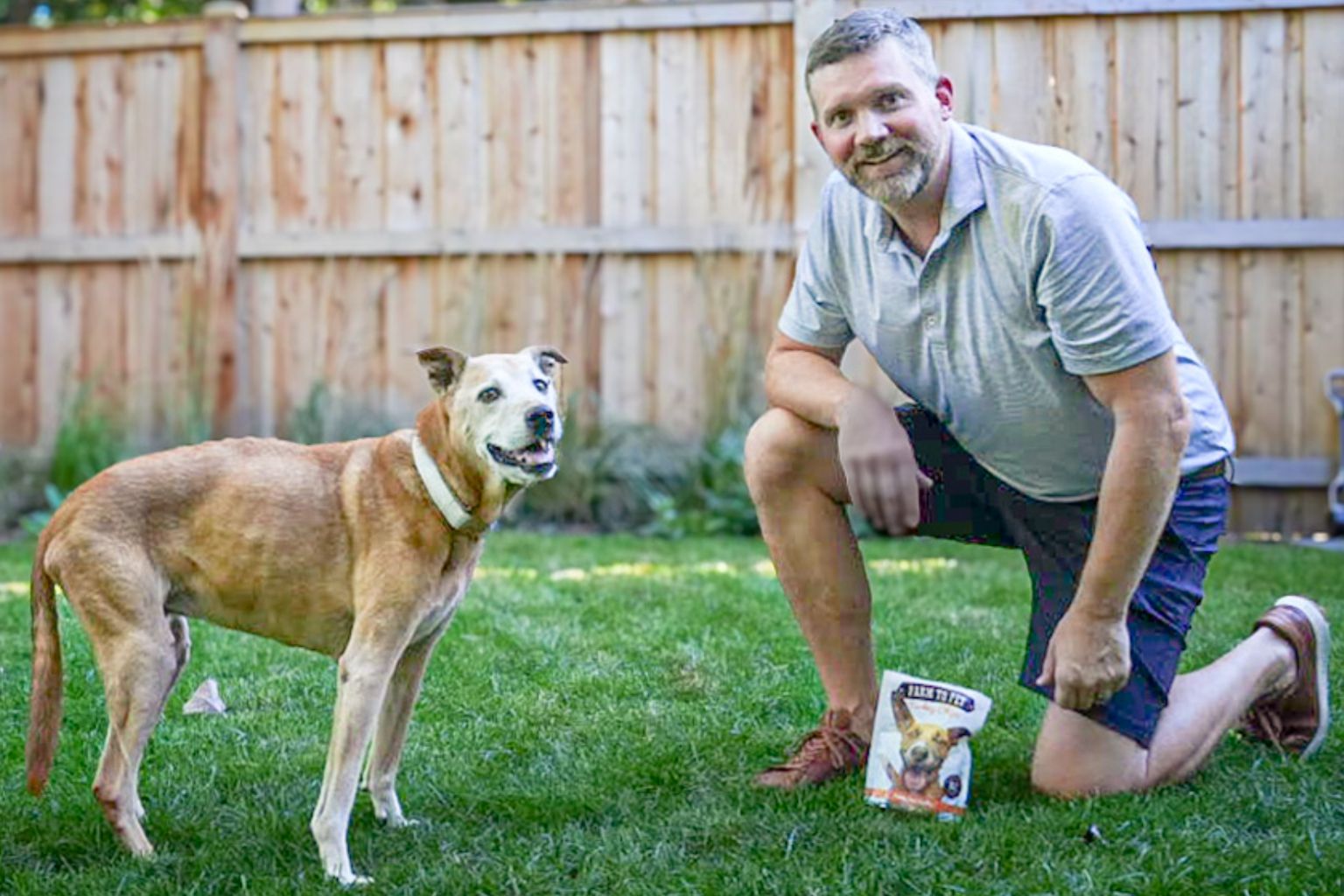 Farm to Pet founder Jackson Jones with his dog Rooney and a bag of Live Like Roo turkey chips dog treats